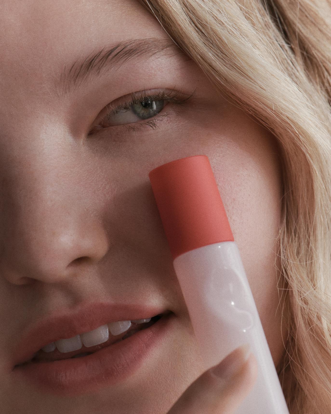 Nena wears Glossier You Travel Spray.