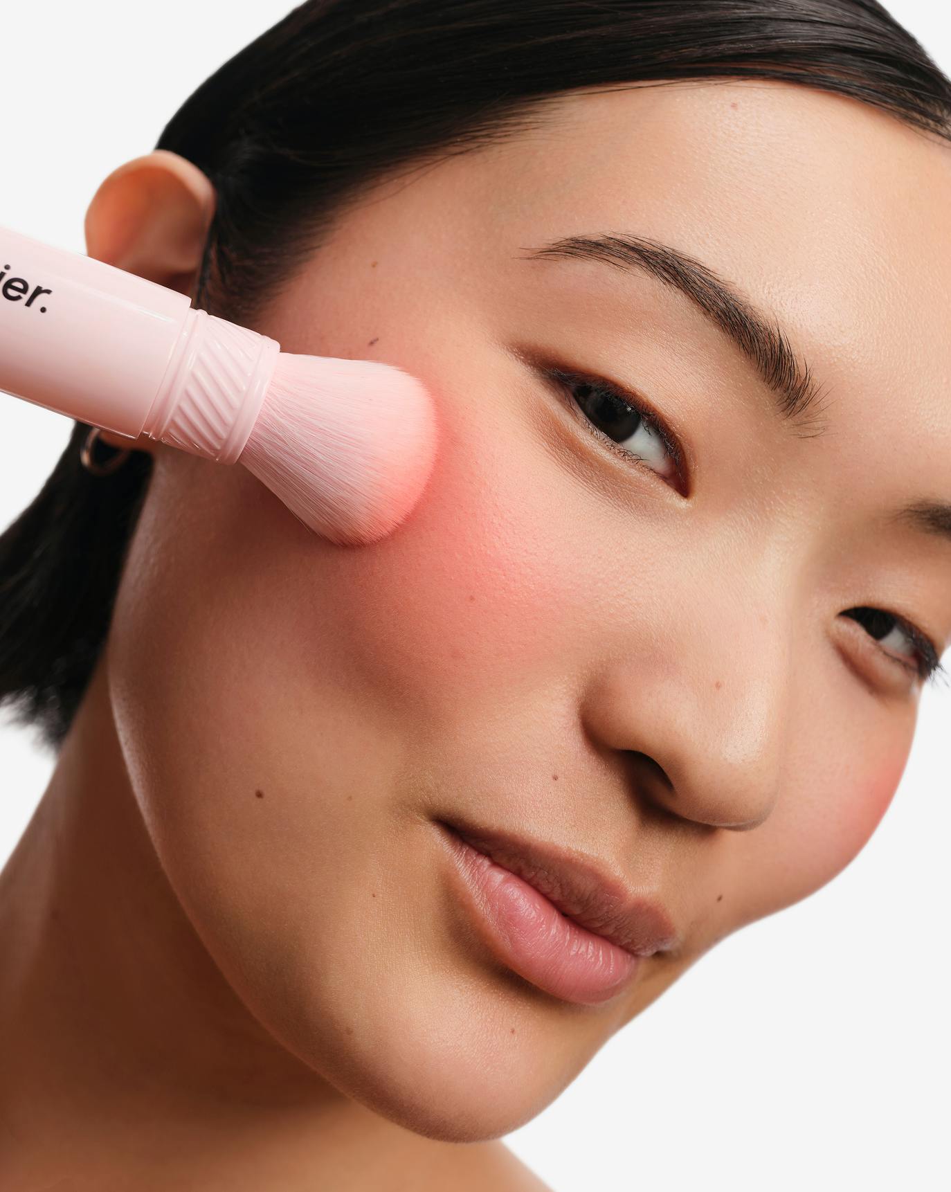 Chris wears Cloud Paint Plush Blush in Beam.