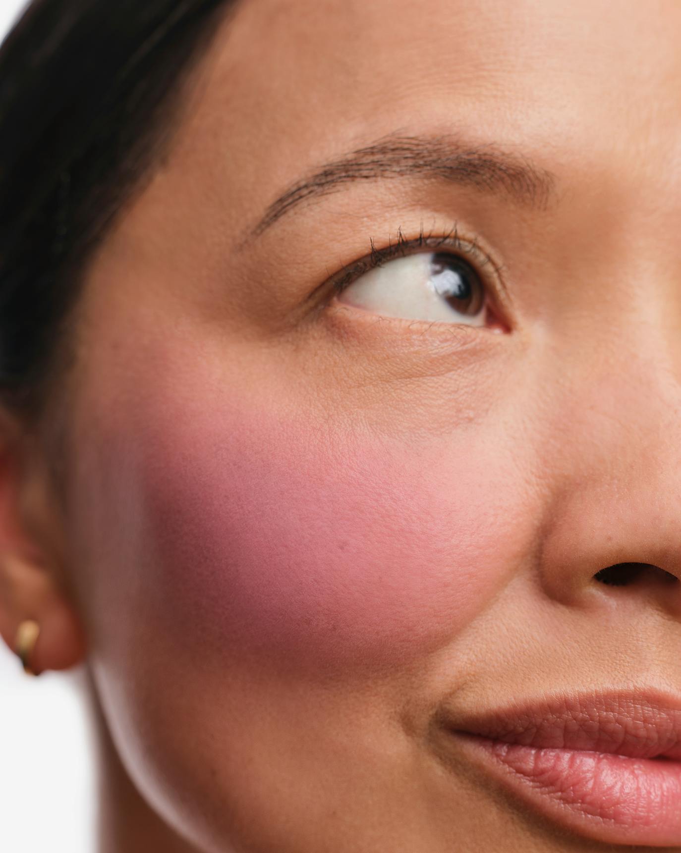 Christine wears Cloud Paint Plush Blush in Bloom.