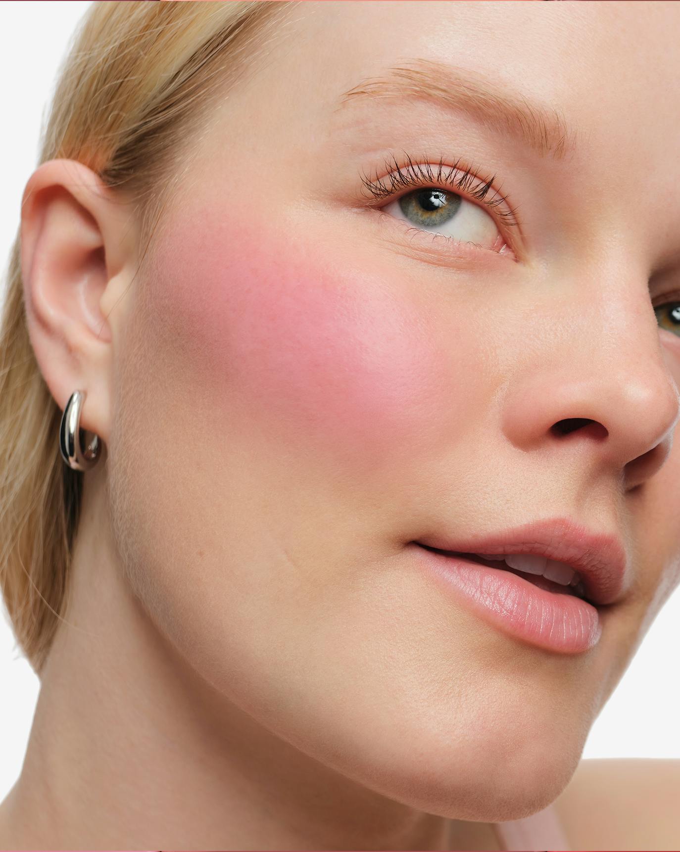 Elynn wears Cloud Paint Plush Blush in Bloom.