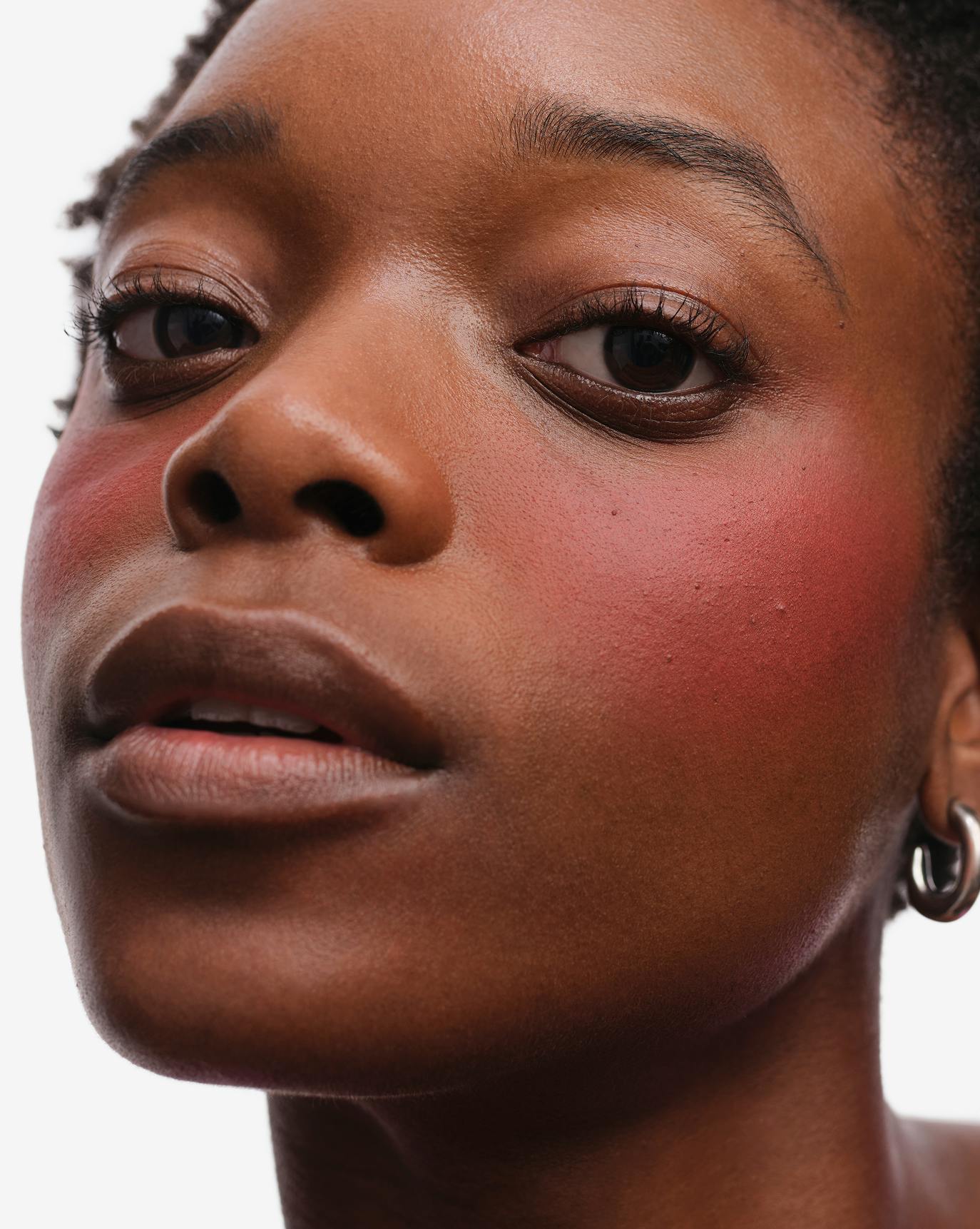 Olivia wears Cloud Paint Plush Blush in Burst.