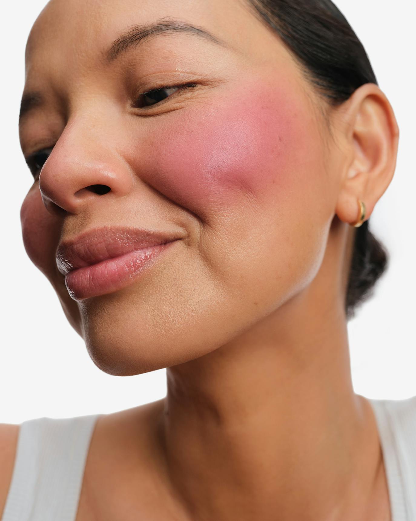 Christine wears Cloud Paint Plush Blush in Plume.