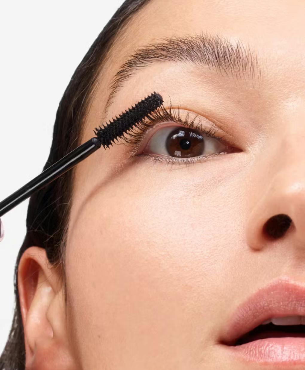 close up of model's eye wearing lash slick brown on eyelashes