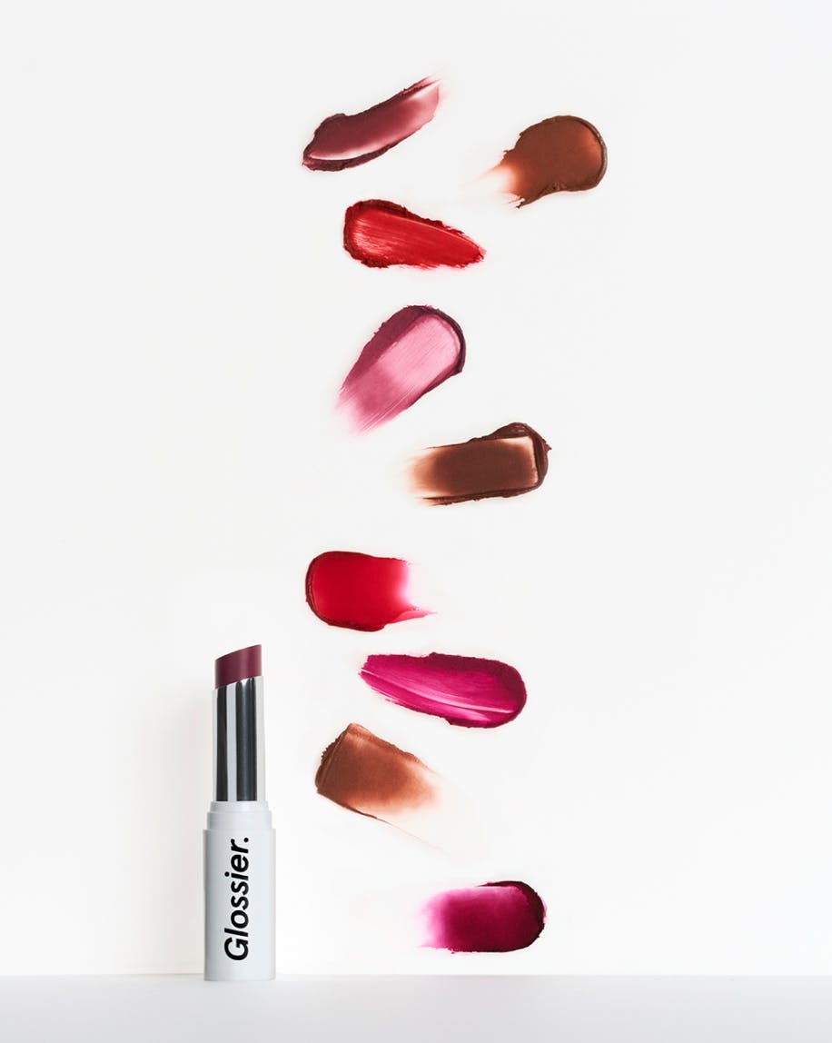 open tube of generation g lipstick in jam with all generation g shade swatches on white background