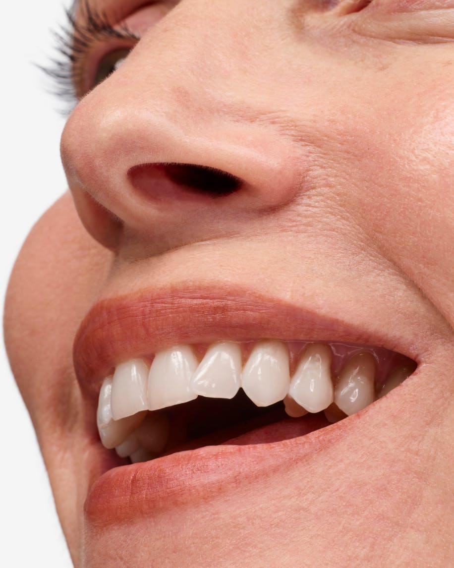 close up of person's smile wearing generation g in leo on lips