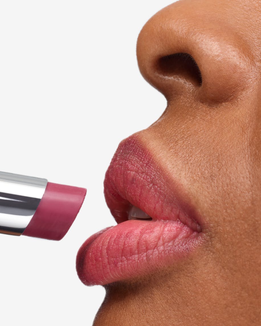 close up of model profile applying generation g in like to lips