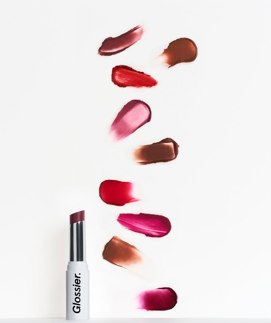 open tube of generation g lipstick in malt and all generation g shade swatches on white background