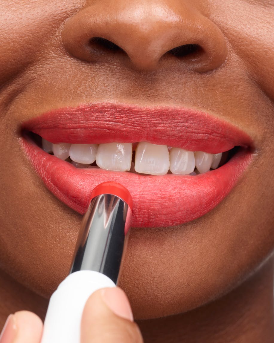 smiling mouth with open tube of generation g zip being applied to smiling mouth