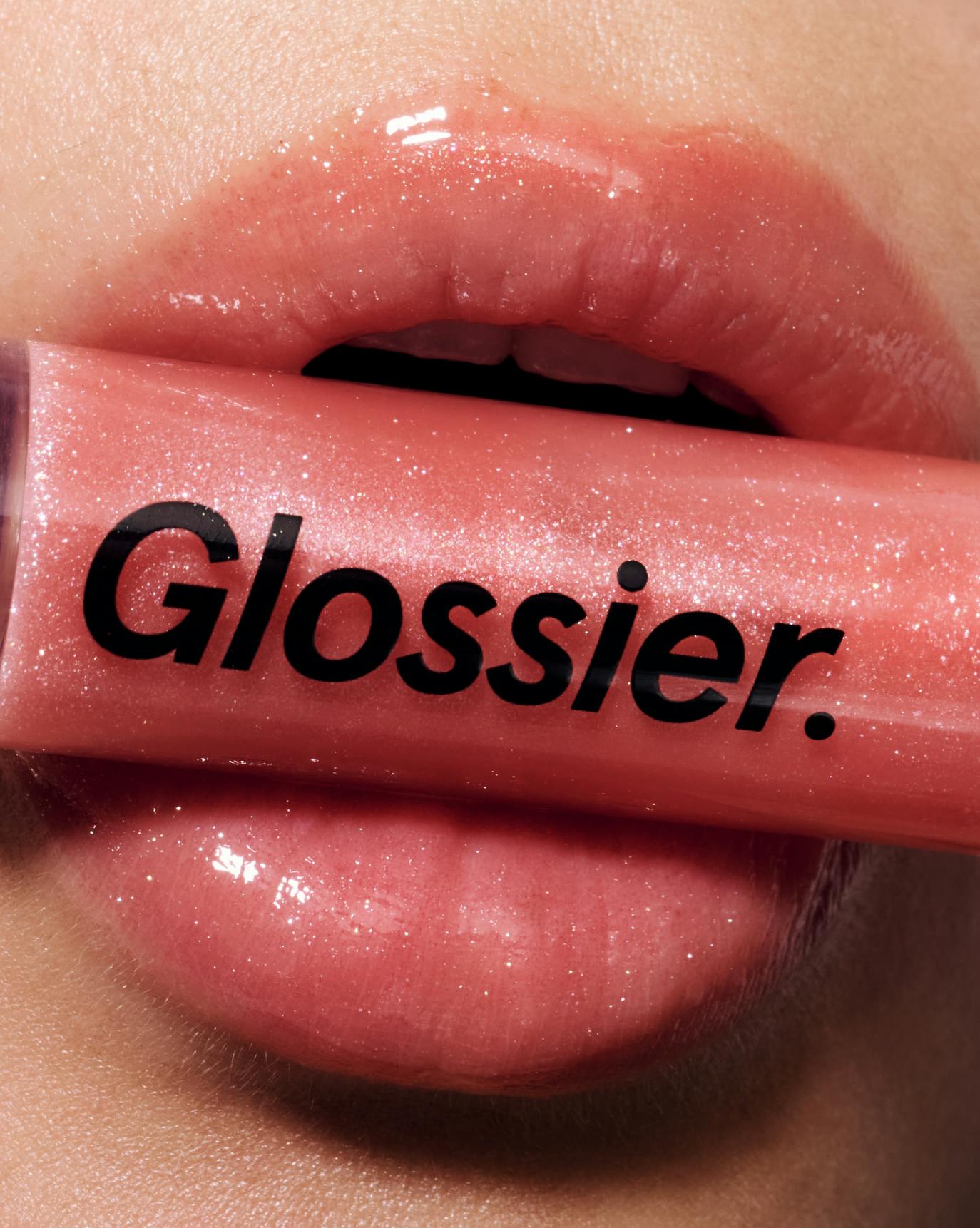 Chloe wears Lip Gloss in Pink.