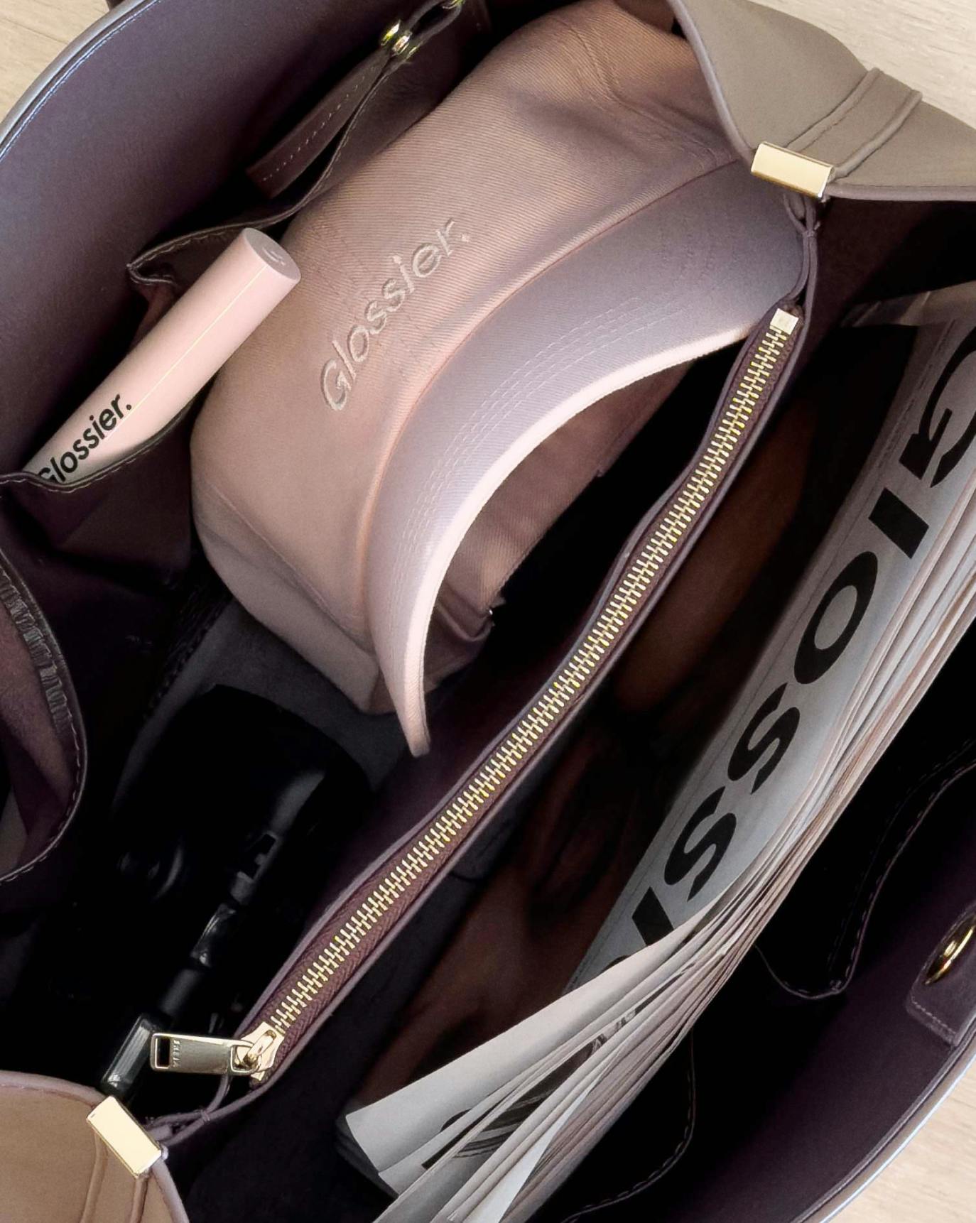 glossier pink cap in tote bag