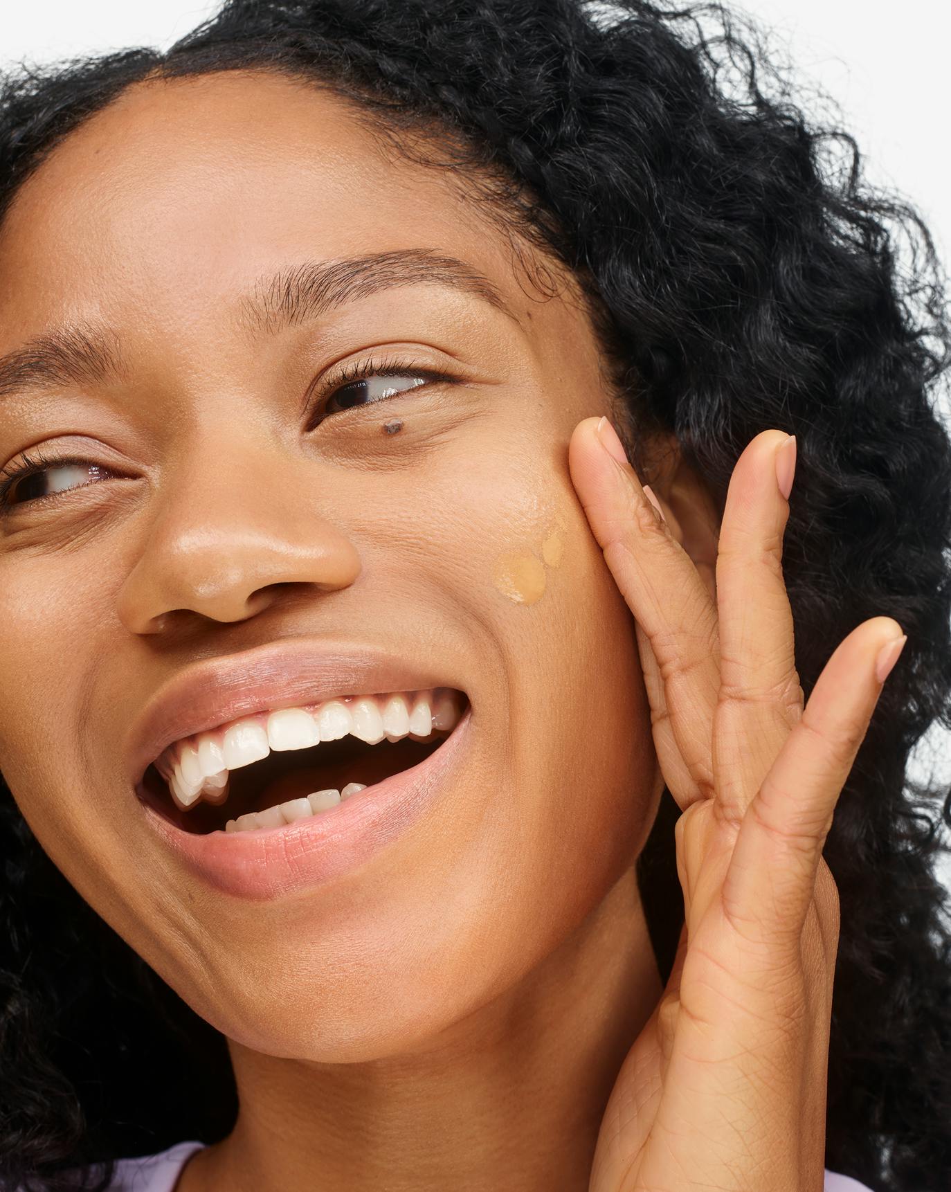 Naome wears Stretch Fluid Foundation in Medium Tan 3.